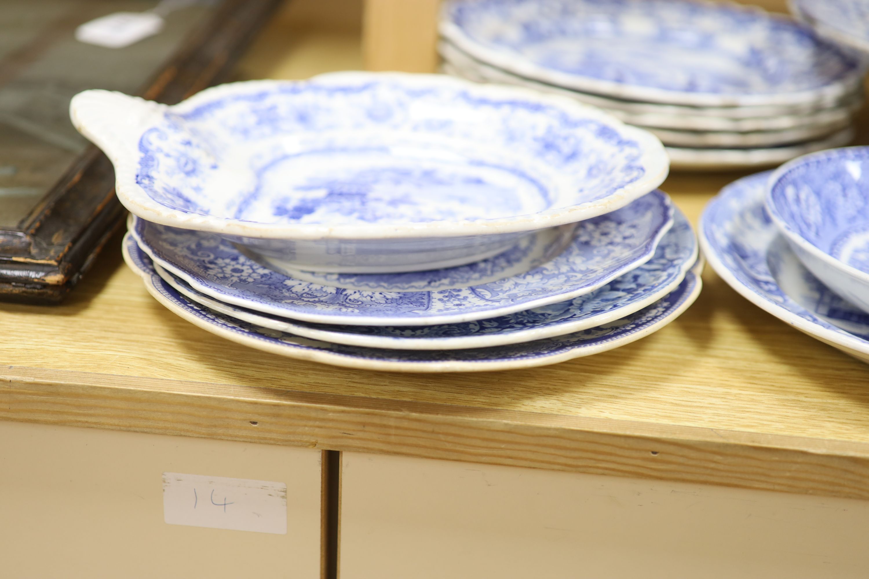 A collection of 19th and 20th century blue and white pottery plates and dishes